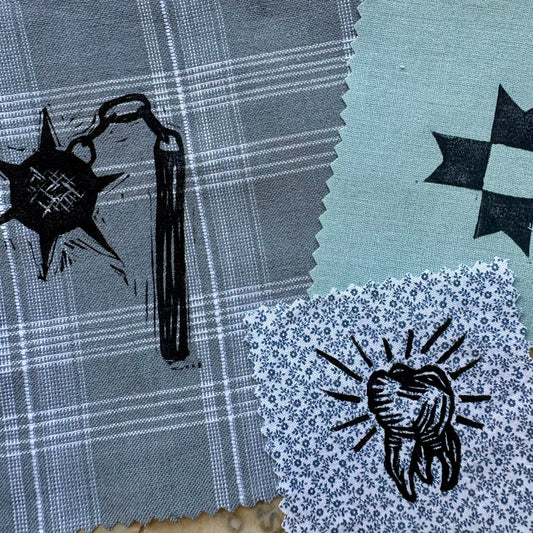 Fabric swatches with printed designs on a textured surface
