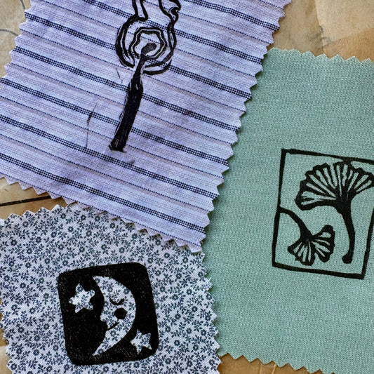 Fabric swatches with printed designs on a textured surface