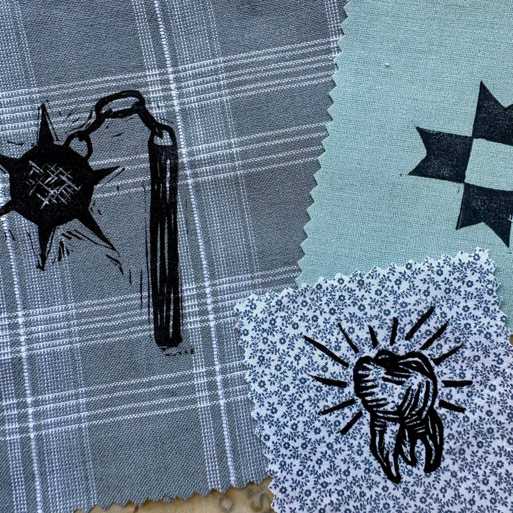 Fabric swatches with printed designs on a textured surface