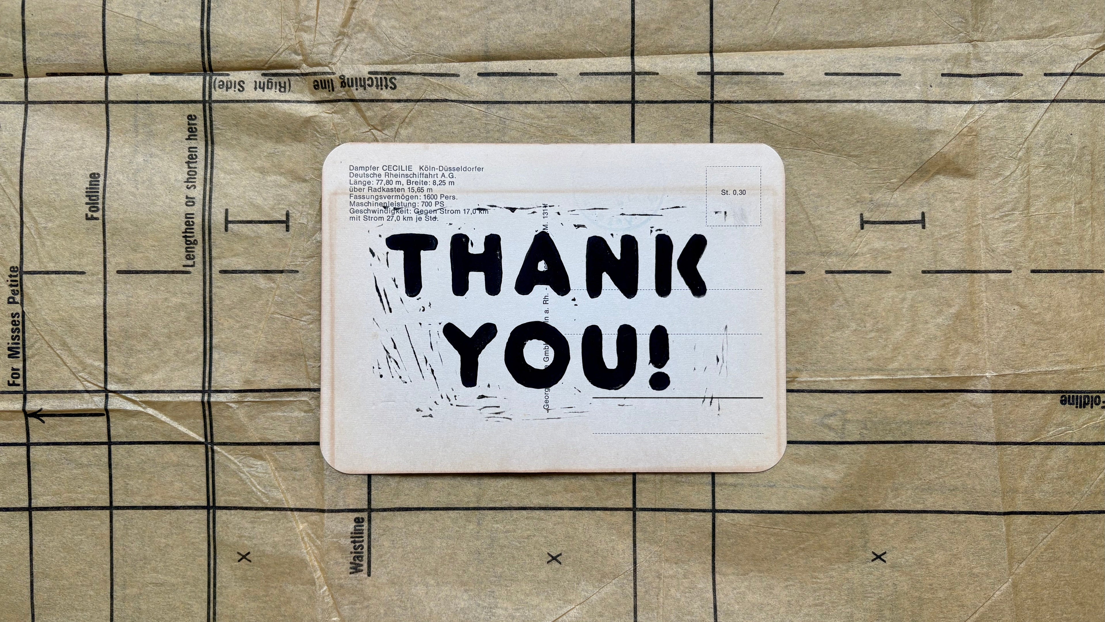 Card with 'THANK YOU!' text on a cardboard background